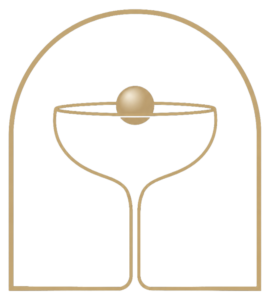 Gold outline drawing of a martini glass with a small gold sphere balanced on its rim, set against a black background inside a rounded gold arch.