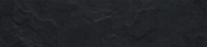 Dark, textured slate surface with irregular, layered rock patterns.